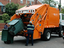 large trash container being emptied into truck