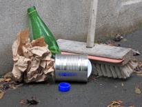 Alley Sweeping photo of broom sweeping up trash